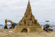 Rio de Janeiro, Brazil -- Caterpillar dispatched a crew of its top demonstration operators to the beach in Rio de Janeiro to work with a team of talented sculptors to build a giant sand castle; over the course of 15 days, trucks delivered 49 loads of sand to the site, where seven machine operators and seven sculptors carefully shifted and shaped it into a 41 ft. 3.67 in. (12.59 m.)-tall sand castle, which sets the new world record for the Tallest Sand Castle, according to the World Record Academy: www.worldrecordacademy.com/.