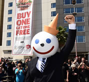 Fast food icon Jack, of Jack in the Box, makes a rare public appearance to celebrate capturing the World Record title for the world's Largest coupon. Measured at a staggering 80 feet tall by 25 feet wide, the world's Largest coupon was first redeemed for a buy one, get one free (BOGO) Buttery Jack burger by Jack himself, along with members of the Los Angeles community, at Jack in the Box's Hollywood restaurant.