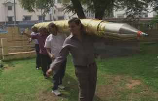  An 18.4 feet-long ball pen made of brass by a government teacher in Nizamabad, M.S. Acharya, being carried by the people after it was unveiled in Hyderabad.