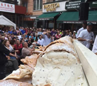 The Executive chef of Ferrara Cafe on Grand Street is the creator of the World's Largest Cannolo. The 12 foot long shell is filled with about 300 pounds of cream and covered with 50 pounds of chocolate chips.
