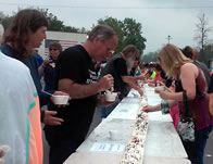 line of vanilla ice cream scoops covered in strawberries, chocolate syrup, whipped cream and cherries stretched 1,800 feet down M-66 in the middle of town.