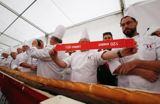 Some 60 French and Italian bakers worked nearly seven hours to bake a 122-meter-long (400-foot-long) baguette at the Milan Expo 2015 World's Fair.