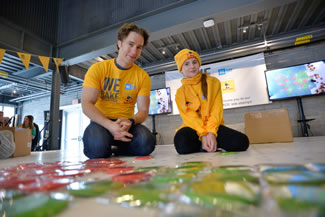 Craig Kielburger, Co-Founder of WE Day and Free The Children with Bella Black, 11 years old, We Bake for Change Ambassador, help the Robin Hood team build the largest cookie mosaic in support of We Bake for Change, an initiative of WE Day. The completed mosaic measured 29.58 feet by 47.71 feet and was comprised of over 13,000 shortbread cookies. 