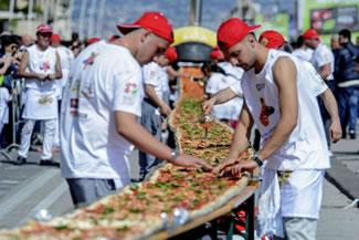 The world's longest pizza was made in Naples and is 1.8km long. It took 250 pizza makers six hours and 11 minutes. They used 2,000kg of flour, 1,600kg of tomato sauce, 2,000kg of mozzarella cheese, 200 litres of oil and 30kg of basil. 