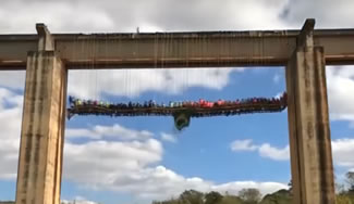 102 absailers rappeled off a 28 metre high abandoned bridge in Sao Paulo state to sit at a large table complete with its own grilling station, suspended 20 metres above ground. Diners tucked into a Brazilian barbecue, called churrasco. 