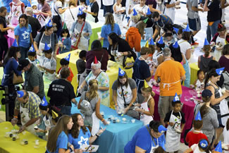 People decorate cupcakes in an attempt to beat a World Record for the most cupcakes iced in one hour during Mall of America's 25th birthday celebration, in Bloomington, Minn. 