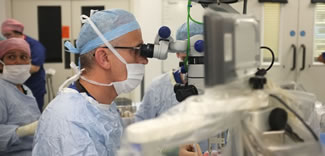 University of Oxford surgeons at Oxford's John Radcliffe Hospital have performed the world's first operation inside the eye using a robot. Robert MacLaren, Professor of Ophthalmology. assisted by Dr Thomas Edwards, Nuffield Medical Fellow, used the remotely controlled robot to lift a membrane 100th of a millimetre thick from the retina at the back of the right eye of the Revd Dr William Beaver, 70, an Associate Priest at St Mary the Virgin, Iffley, Oxford. 