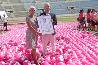 World Health Oorganization's Representative in Lebanon Dr. Gabriele Reidner and Minister holding the certificate proudly and standing inside the ribbon.