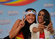 Photo: Degrassi star Melinda Shankar and a proud Canadian help Skittles break the Guiness World Records for the most Selfies taken in one hour, making history on Canada Day. (CNW Group/Wrigley)