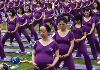 Pregnant women practice yoga as they attempt to break the Guinness World Record for the largest prenatal yoga class, in Changsha, Hunan province.