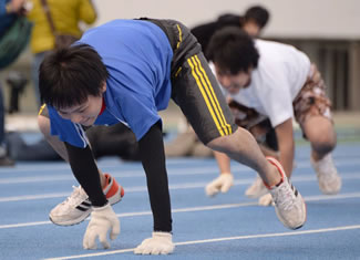 Competitors run with their arms and legs during the quadrupedal 100 metre dash in Tokyo. Japanese man Kenichi Ito clocked 15.71 seconds to break his own world record in the competition and was certified as "Fastest 100m on All Fours".