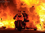 Stuntmen Enrico Schoeman and Andre De Kock ride their motorcycle with side car through a tunnel of fire in their attempt at setting a world record, 5 September 2014, at the Rhino Rally in Parys. The two were successful in riding through a 120.4 metre tunnel.