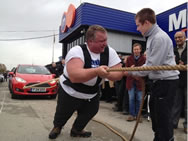Simon Plant, 42, of Findern, England, pulled a rope attached to 14 Ford Fiestas at Motorpoint in Derby and moved the line of cars 18 feet and 2 inches to break the Guinness world record of pulling 12 cars a distance of 15 feet.