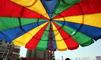 The 14.4 meters (47.2 feet) high umbrellas have a diameter of 23 meters (75.5 feet) when opened. The umbrella, weighing 5.7 tonnes and standing in a plaza, covers a 418 sq.m. area.