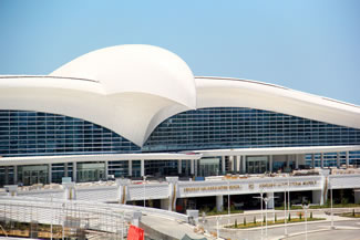 The bird sits fully on top of the main passenger terminal ( see attached plan and section). The passenger terminal is a building on its own that is connected to the pier structure behind it.