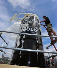 Photo: Brewery co-founder Angus Wood fills a giant beer glass with with 3,664 pints of Stod Fold's Gold ale, one pint for every kilometre of the Tour de France.