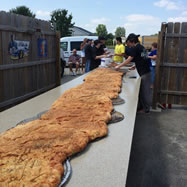 MIDDLEBURY, IN, USA -- Employees and supporters of the Rulli's Italian Restaurant in Middlebury successfully baked a nine foot long, 22 inch wide, 70 pound calzone - breaking the previous Guinness World Records' record, as part of a fundraiser for the Middlebury Boys and Girls Club, according to the World Record Academy: http://www.worldrecordacademy.com/.