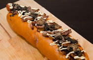 The 'Juuni Ban' contains smoked cheese bratwurst, butter Teriyaki grilled onions, Maitake mushrooms, Wagyu beef, foie gras, shaved black truffles, caviar and Japanese mayonnaise on a brioche bun. 