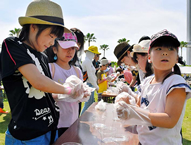 Children hurriedly hand-roll rice balls at an event in Sakaide, Kagawa, Japan. Hundreds of young and old participants teamed to set a World Record in this city, hand-rolling 668 "omusubi" rice balls over a five minute time limit. 
