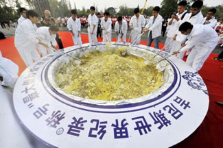 Participants stir a giant bowl of fried rice during a Guinness World Record attempt of the largest serving of fried rice, in Yangzhou, Jiangsu province, China. The giant pot of fried rice was cooked to mark the 2500 anniversary of the establishment of Yangzhou City. The event was organized by the World Association of Chinese Cuisine, Tourism Bureau of Yangzhou and the Yangzhou Association of Cuisine.