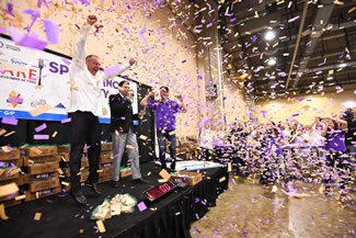 David Jobe, chief customer officer of Winsight Events (left), and Jeff Sinelli, founder, CEO and chief vibe officer of Which Wich, react to the Guinness World Records monitor (center) announcing that the crowd had smashed the record.