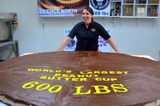 Northwest Fudge Factory has successfully created the world's largest peanut butter cup, weighing in at 600 pounds. The previous world record, made by a chocolate shop in Los Angeles, was 440 pounds.