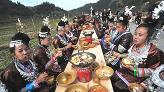 The Chinese ethnic minority group Dong from the central and southern mountains of China, broke the Guinness world record for the world's longest feast table with more than 10,000 people seated at a 3.7 kilometer (2.3 miles) long table. 