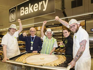  Asda Barnstaple store manager Andy Felix and bakery manager Nicole O'Connor with members of the bakery team and the gigantic 31 inch Easter biscuit.