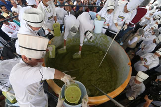 Volunteers from a culinary school mix mashed avocados as they attempt to set a new World Record for the largest serving of guacamole in Concepcion de Buenos Aires, Jalisco, Mexico. 