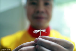 Chef Li Hongkai holds a needle threaded with 42 noodles in Sichuan Province, December 19, 2017. The master chef is capable of producing noodles as thin as 0.067 of a millimeter, which is a World Record for the Thinnest Handmade Noodles. Li Hongkai can create noodles which can regularly be passed through the eye of a needle between 30 to 40 times.