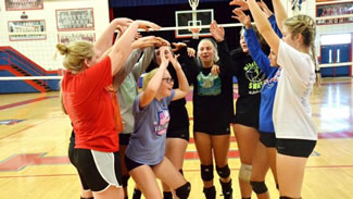  THE LADY PATRIOT volleyball team gathers for a brief celebration huddle after setting a new world record for most consecutive volleyball passes.