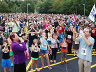 More than 1,000 horn players blew their way into the history books in Whippany, setting a new record for the world's largest shofar ensemble. Rabbi Amy Small, left, and Eric Freedman lead the crowd in the record-blasting shofar blow on Sept. 21. Photos by Elaine Durbach.