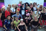 Sporting the many looks of Madonna, organizers of the 19th annual Fool's Paradise Drag Party in Fire Island Pines pose with an adjudicator from Guinness World Records on Saturday, Aug. 30, 2014, after setting the record for 