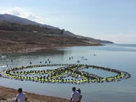  Employees and management from hotels in the Dead Sea area join forces to break the Guinness World Record of the largest floating human image showing a peace sign at the lowest point on earth, at the Dead Sea Spa Hotel Beach, Jordan.