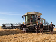 The Darling family, Warren and Joy flanked by son Craig, right, and Warren's father George with sons Andrew, left, and Brad and Andrew's partner Amy on the header, in the record barley crop field at their Poplar Grove Farm near Timaru.