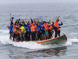 A total of 66 surfers have broken the world record for the most people riding on a surfboard at once. A crowd of 5,000 spectators watched the group as they rode the board for 12 seconds.