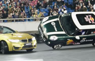 A driver in a BMW M4 Coupe has claimed a new World Record for completing the "most donuts around a car driving on two wheels in one minute." The record breaking attempt was completed earlier this month in Chongqing, China when Zhang Shengjun managed to complete ten donuts around a MINI Cooper being driven on two wheels by Han Yue. 