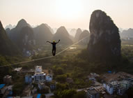 Alexander Schulz from Germany managed to break the Guinness World Records' record for the longest distance walked on a highline in Guilin, Guangxi, where he spent days crossing a 375-meter-long rope while balancing 100 meters above ground - setting the new world record for the Longest distance walked on a highline, according to the World Record Academy: www.worldrecordacademy.com/.